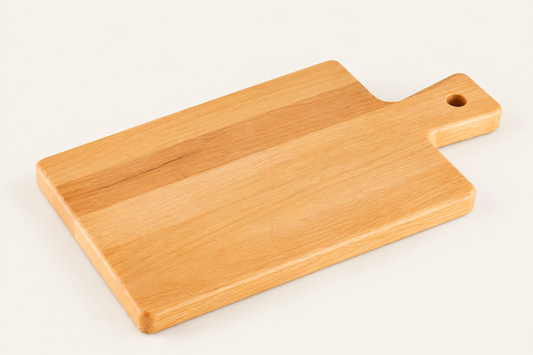 A rectangular wooden cutting board with rounded corners and a handle featuring a hanging hole, shown on a clean off-white background.