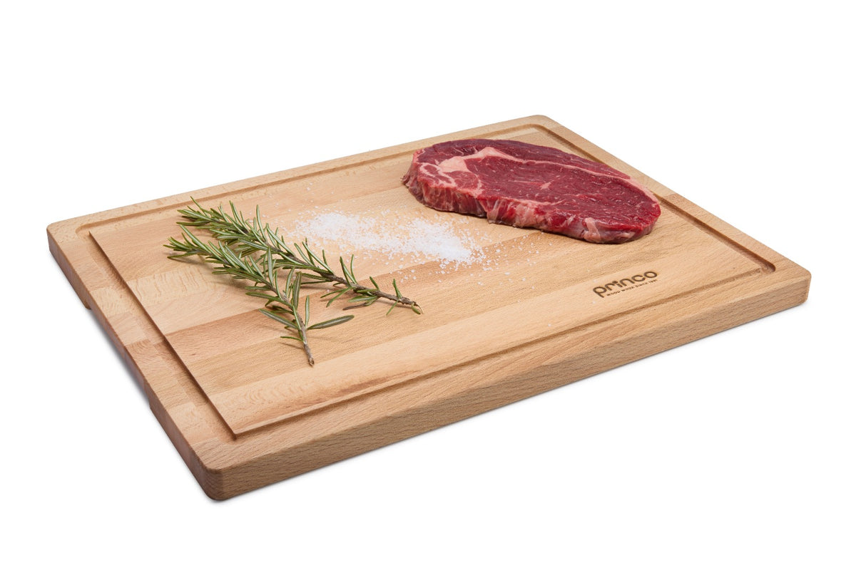 Large rectangular beech wood cutting board with a juice groove that catches liquids when carving meat, slicing fruit or chopping vegetables. Solid oiled beech offers a stable, durable, knife-friendly surface. Size: 400 x 300 x 20 mm.